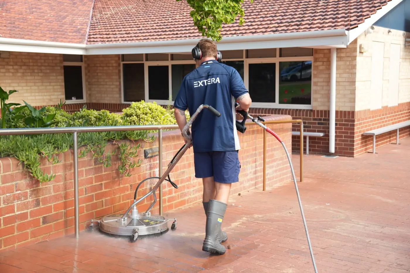 Extera cleaning a commercial school forecourt with a surface cleaner in Perth